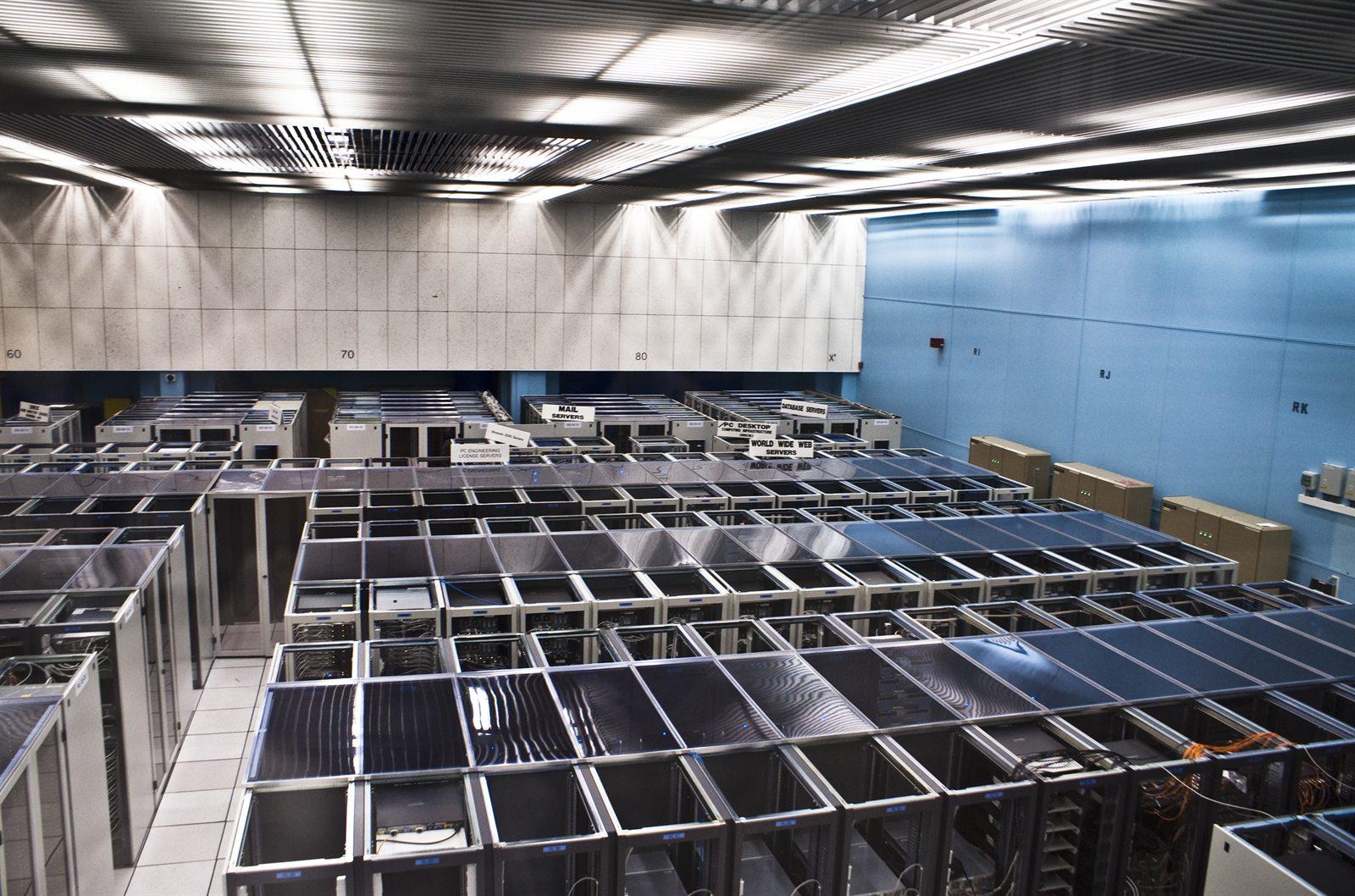 Rows of server cabinets in a large data centre hall