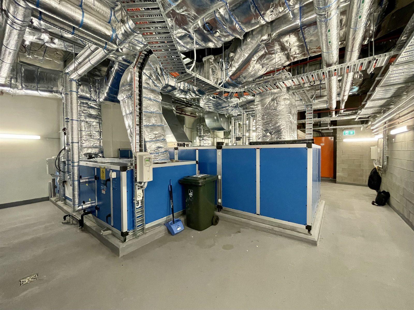 Air handling units beneath insulated ductwork in a plant room